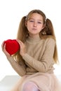 Beautiful girl holding red heart