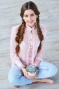 Beautiful girl holding succulent flower pot