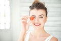 Beautiful girl holding up cherry tomato Royalty Free Stock Photo
