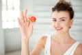 Beautiful girl holding up cherry tomato Royalty Free Stock Photo