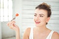 Beautiful girl holding up cherry tomato Royalty Free Stock Photo