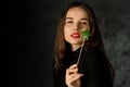 Beautiful girl holds a magic wand with a candy in the shape of a star Royalty Free Stock Photo