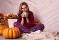 Beautiful girl at home in pajamas. Beautiful young woman and pumpkins. Autumn girl Royalty Free Stock Photo