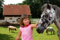 The beautiful girl and horse on a farm