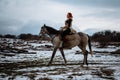 Beautiful girl on horse and with red hair in armor. Woman is a Viking. Fantasy