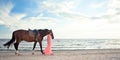 Beautiful girl with horse on seacoast Royalty Free Stock Photo