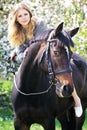 Beautiful girl and horse in spring garden Royalty Free Stock Photo