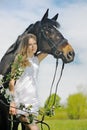 Beautiful girl and horse in spring garden Royalty Free Stock Photo
