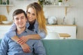 Beautiful girl hugging a guy in the kitchen