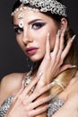 Beautiful girl in image of Arab bride with expensive jewelry, oriental make-up and bridal manicure. beauty face.