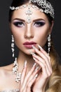 Beautiful girl in image of Arab bride with expensive jewelry, oriental make-up and bridal manicure. beauty face.