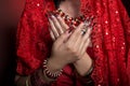Beautiful girl in the image of Indian woman in a red sari with beautiful patch acrylic nails in oriental style in the studio Royalty Free Stock Photo