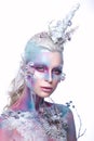 Beautiful girl in the image of a snowy unicorn creature. Creative make up. Art look.