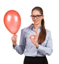 Girl with inflated balloon shows that all okay