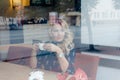 Beautiful girl inside a cafe with cup of coffee Royalty Free Stock Photo