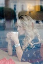 Beautiful girl inside a cafe with cup of coffee Royalty Free Stock Photo