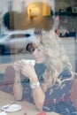 Beautiful girl inside a cafe with cup of coffee Royalty Free Stock Photo