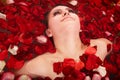 Beautiful girl in jacuzzi with rose petal. Royalty Free Stock Photo