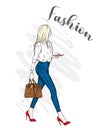 A beautiful girl in jeans, a blouse and in high-heeled shoes. A stylish woman with long hair and a bag. Fashion and style.