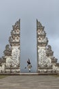 Beautiful Girl Jumping Near Gates Of Heaven In Pura Lempuyang Temple In Bali, Indonesia. Royalty Free Stock Photo