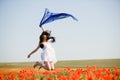 Beautiful girl jumping in the poppy field Royalty Free Stock Photo