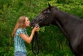 A Beautiful girl kissing her handsome horse Royalty Free Stock Photo