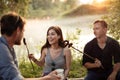 Beautiful girl is laughing as she has overcooked the sausage