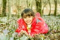 Beautiful girl laying in the flowers in the forest