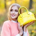 Beautiful girl with a leather bag in the autumn on the nature Royalty Free Stock Photo