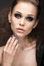 Beautiful girl in leather jacket with bright makeup and manicure Cat's Eye. Beauty face. Nail Design. Royalty Free Stock Photo