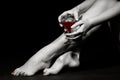 Beautiful girl legs and a glass of red wine Royalty Free Stock Photo