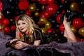 Beautiful girl in a dress on a studio in a ballons background