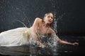 Beautiful girl lies on floor and sprays water Royalty Free Stock Photo