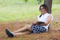 Beautiful girl lies on meadow and reads the book Royalty Free Stock Photo