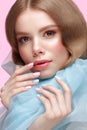 Beautiful girl with light make-up and gentle manicure in blue clothes. Beauty face. Design nails. Royalty Free Stock Photo