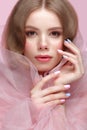 Beautiful girl with light make-up and gentle manicure in pink clothes. Beauty face. Design nails. Royalty Free Stock Photo