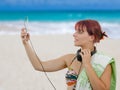 Beautiful girl listening music with her smartphone on the beach Royalty Free Stock Photo