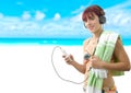 Beautiful girl listening music with her smartphone on the beach Royalty Free Stock Photo