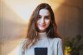 Beautiful girl listening to music in earphones. Young female model with long hair and pretty face posing at photo session. Great Royalty Free Stock Photo