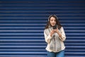 Beautiful girl listens music with blue background Royalty Free Stock Photo