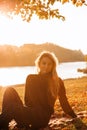 Beautiful girl with long blond hair in autumn landscape at sunset. Autumn portrait of a girl, selective focus Royalty Free Stock Photo