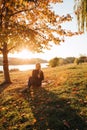 Beautiful girl with long blond hair in autumn landscape at sunset. Autumn portrait of a girl, selective focus Royalty Free Stock Photo