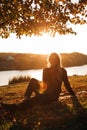 Beautiful girl with long blond hair in autumn landscape at sunset. Autumn portrait of a girl, selective focus Royalty Free Stock Photo