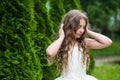 Beautiful girl long curly hair wearing white dress, innocence and tenderness concept Royalty Free Stock Photo