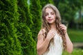 Beautiful girl long curly hair wearing white dress, tenderness and youth concept Royalty Free Stock Photo