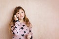 Little girl is talking on a mobile phone Royalty Free Stock Photo