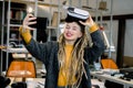 Beautiful girl with long dreadlocks, posing with virtual reality glasses on head, while making selfie photo on her Royalty Free Stock Photo