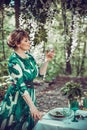 A beautiful girl in a long dress is laying on a table in the woods. Royalty Free Stock Photo