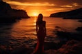 Beautiful girl in a long evening dress on the seashore at sunset, Epic red sunset in Cala Llentrisca with model , Ibiza, AI Royalty Free Stock Photo