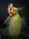 Beautiful girl in a long green dress with a grass Royalty Free Stock Photo